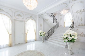 luxury royal posh interior in baroque style. very bright, light and white hall with expensive...