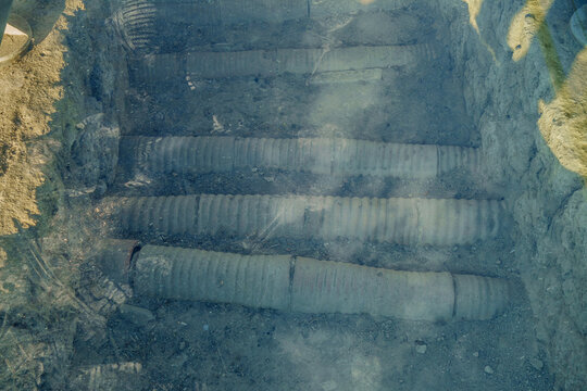 Remains of antique underground pipelines, part of urban water transportation system in Laodicea, ancient city near Denizli, Turkey. Construction protected by thick glass for safety