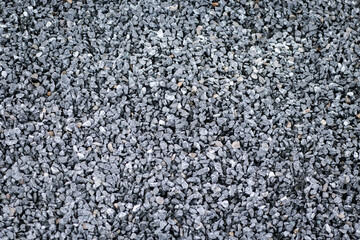 Ground stone grey background of many small stones. Rock texture background..