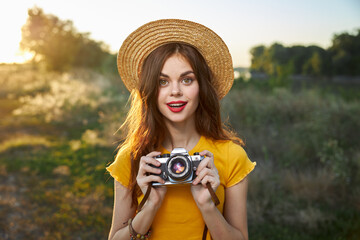 pretty woman holding camera in hands nature fresh air lifestyle