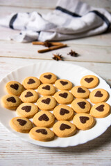 Freshly baked cookies in a white plate with use of selective focus.