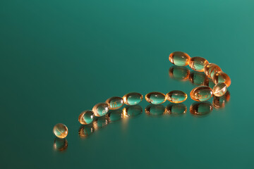 Prescriptions drugs in the form of a question mark on a green back ground