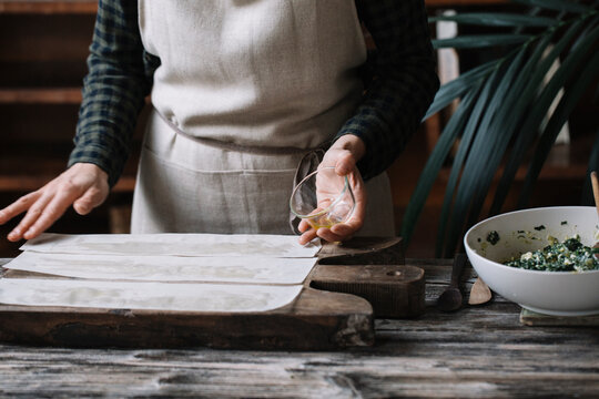 Chef oiling phyllo dough sheets