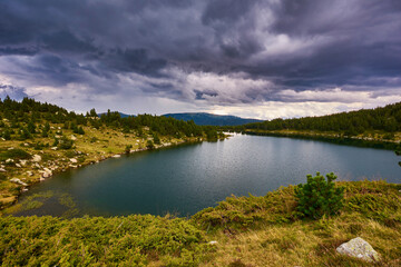 Lake in the mountains under a dramatic sky