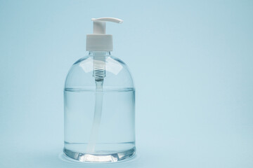 Dispenser of antibacterial gel on blue background