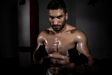 Fototapeta na wymiar Portrait of a young boxer, kick boxer ready for fight