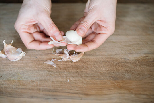 Person peeling garlic