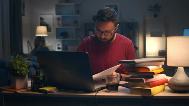 Man working with laptop at home in living room