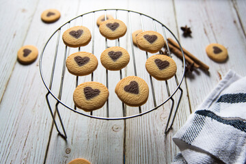  Close up of heart shaped cookies arranged on a grill stand on a background