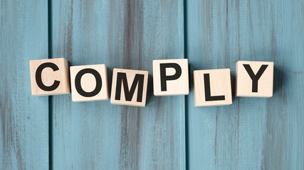 COMPLY word written on building blocks concept