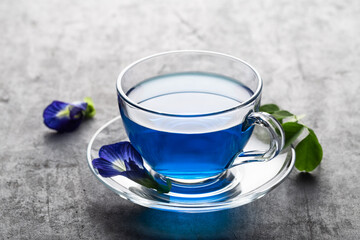 Butterfly pea blue pea tea on grey concrete background.