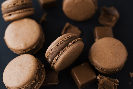 Chocolate macaroons on a black background