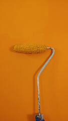 A paint roller against the wall