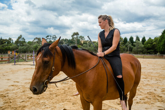 A woman rides her horse bareback