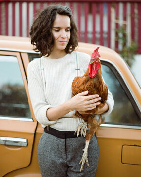 Woman with chick near a car