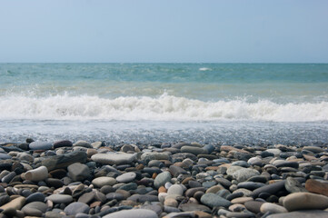 A small storm three or four points at sea, the wave hits the shore with a large pebble. Black Sea, summer vacation vacation beach travel