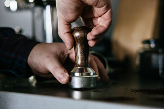 Barista tampering coffee