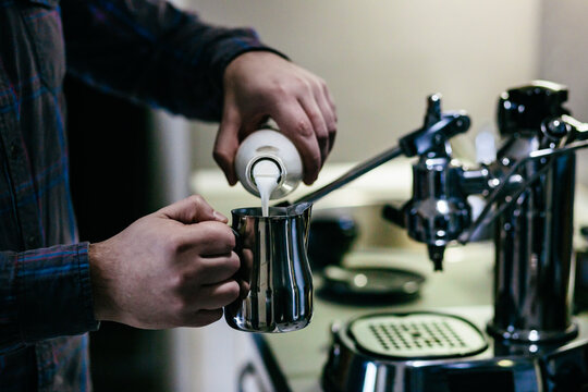 Barista pouring milk