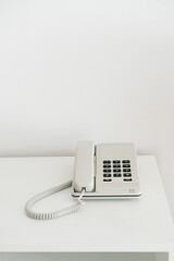 Push-button telephone with a receiver on a light background