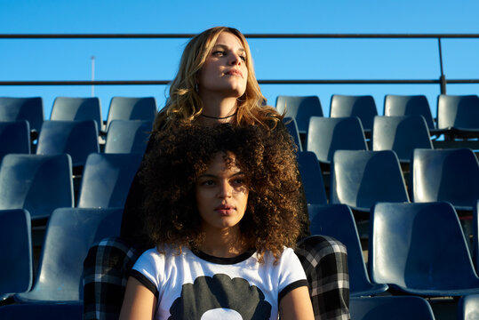 Beautiful girls on grandstand in sunlight.