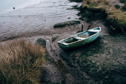 Old rowing boat on the mud flats at Morston Quay, Norfolk, UK.