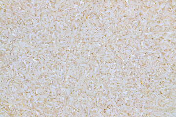 White rice flat lay. Rice cereal photo texture. Whole grain long rice top view. Chinese and...