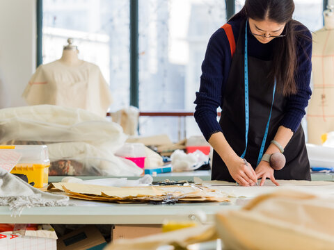 young fashion designer drafting sewing pattern