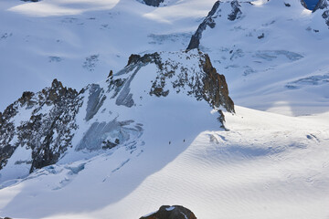 White snowy valley with glaciers and mountain peaks. View from Aiguille du Midi, Chamonix, France.
