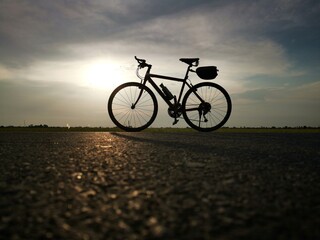 Fototapeta premium Silhouette photo of bike on the road