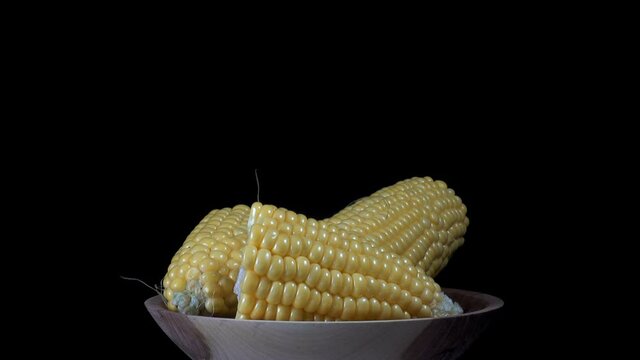 Pieces Of Corn On A Plate Rotate In 4K On A Black Background