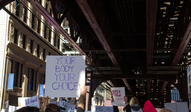 protest signs under the el tracks, Chicago