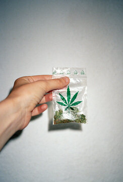 Hand with a pack of cannabis
