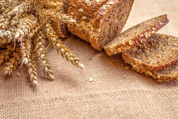 Freshly baked bread. Fresh loaf of rustic traditional bread with wheat grain ear or spike plant on...