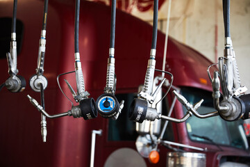 Oil valves hang showing gauges in mechanics garage servicing diesel transportation trucks