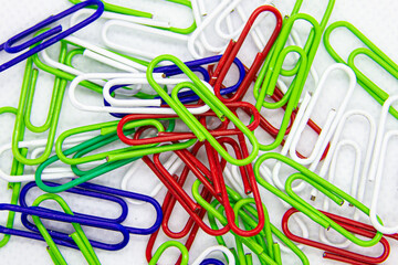 colored paper clips on white