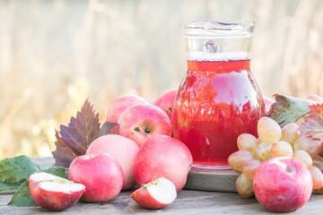 Homemade Apple Cider or Juice or Grape beverage on Wooden Background