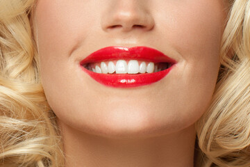 Close up female smile with white teeth and red lipstick makeup