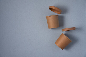 paper cups for food on rose on a blue background in the top view