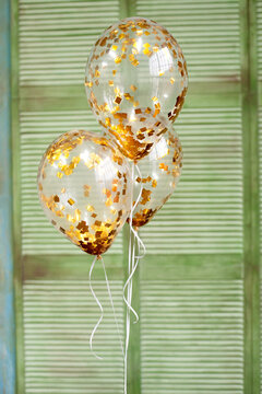 Ballons With Gold Confetti On Green Background