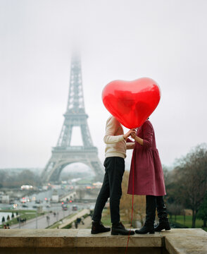 Couple kissing on the background of the Eiffel Tower
