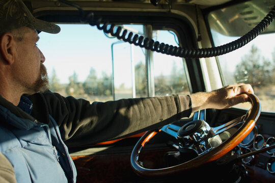 truck driver sitting in driver's seat of truck