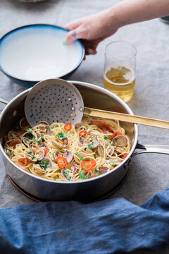 Spaghetti alle vongole being served at a table.
