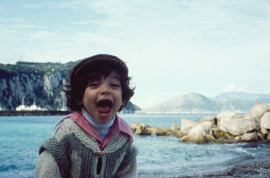 1981. Father kissing his son on the cheek