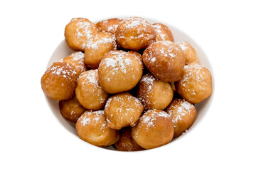 sweet donuts laid out pyramid sprinkled with powdered sugar on the plate