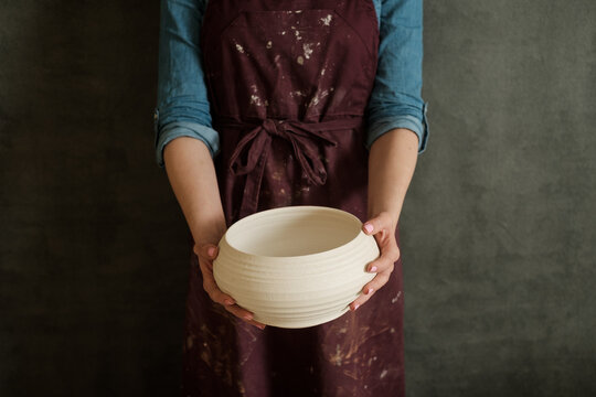 Potter Holding Clay Bowl