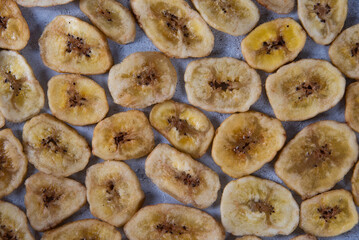 banana chips laid out in a pattern on a gray background