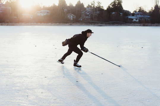 Man skating on frozen lake
