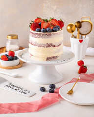 Red Velvet cake, fruits on top and decorations.