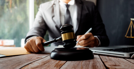 Business and lawyers discussing contract papers with brass scale on desk in office. Law, legal services, advice, justice and law concept picture with film grain effect