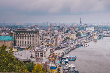 Ukraine. Kiev. View from the pedestrian bridge to the Dnieper River and Poshtovaya Square. Kiev in cloudy weather.